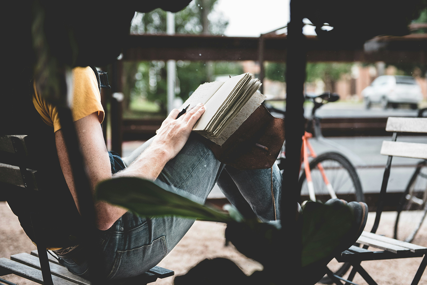 Woman writing in a journal in an outdoor setting