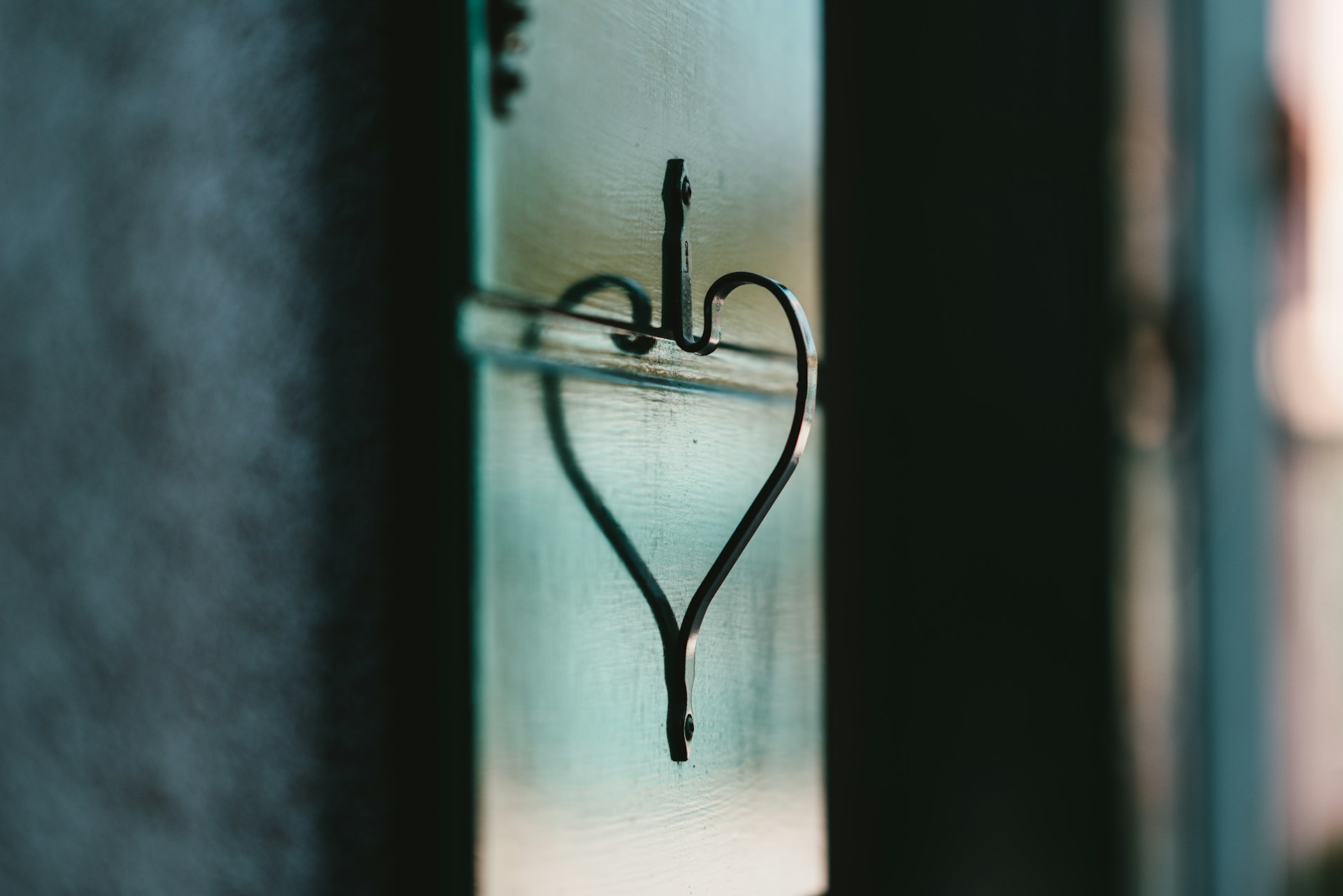 Heart shape made from the reflection of a curved door handle