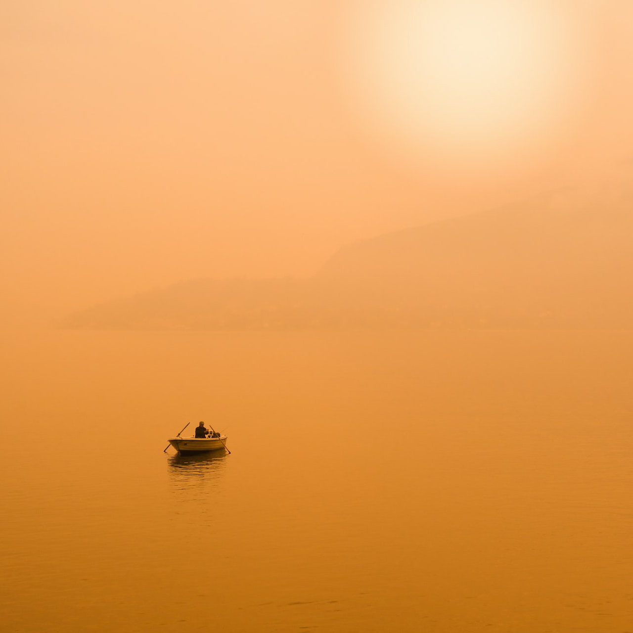 fisherman at the end of the day in the yellow sunset light