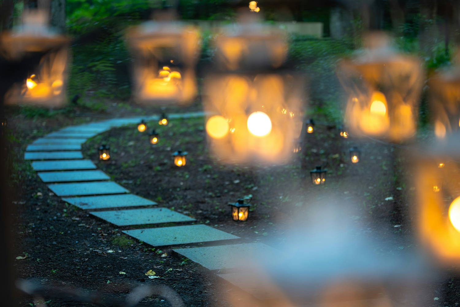 Stone path lit by small lanterns