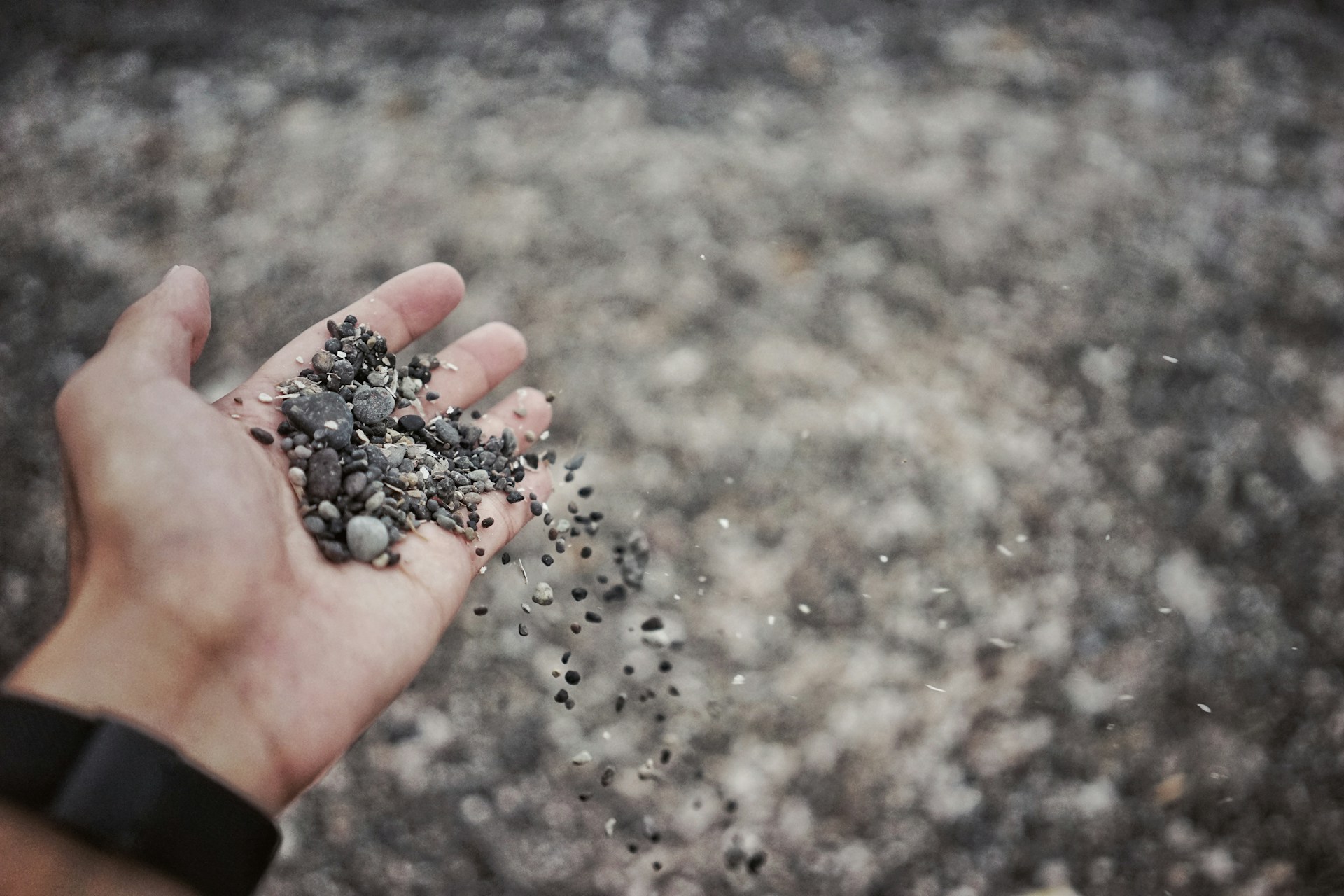 Small rocks falling out of a man's hand