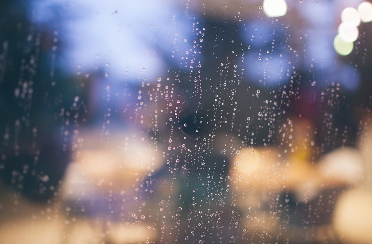 Rain blurs the view from a window