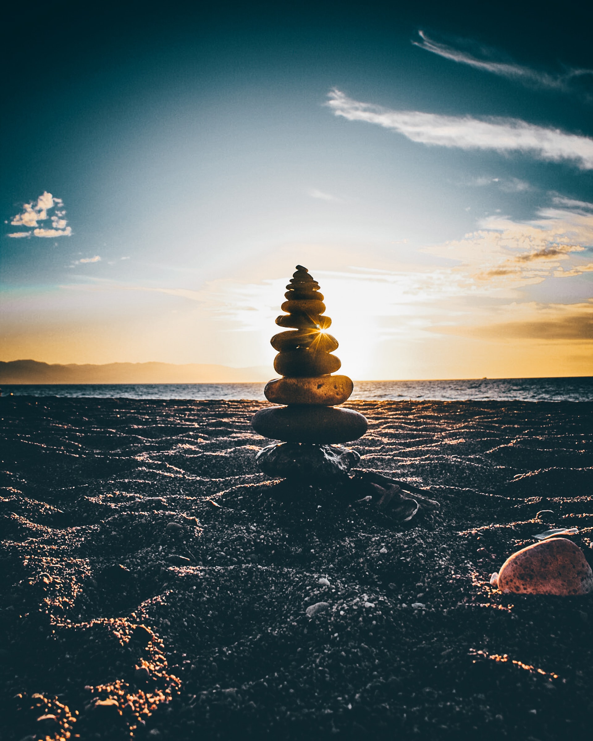 rock cairn at the beach at sunset