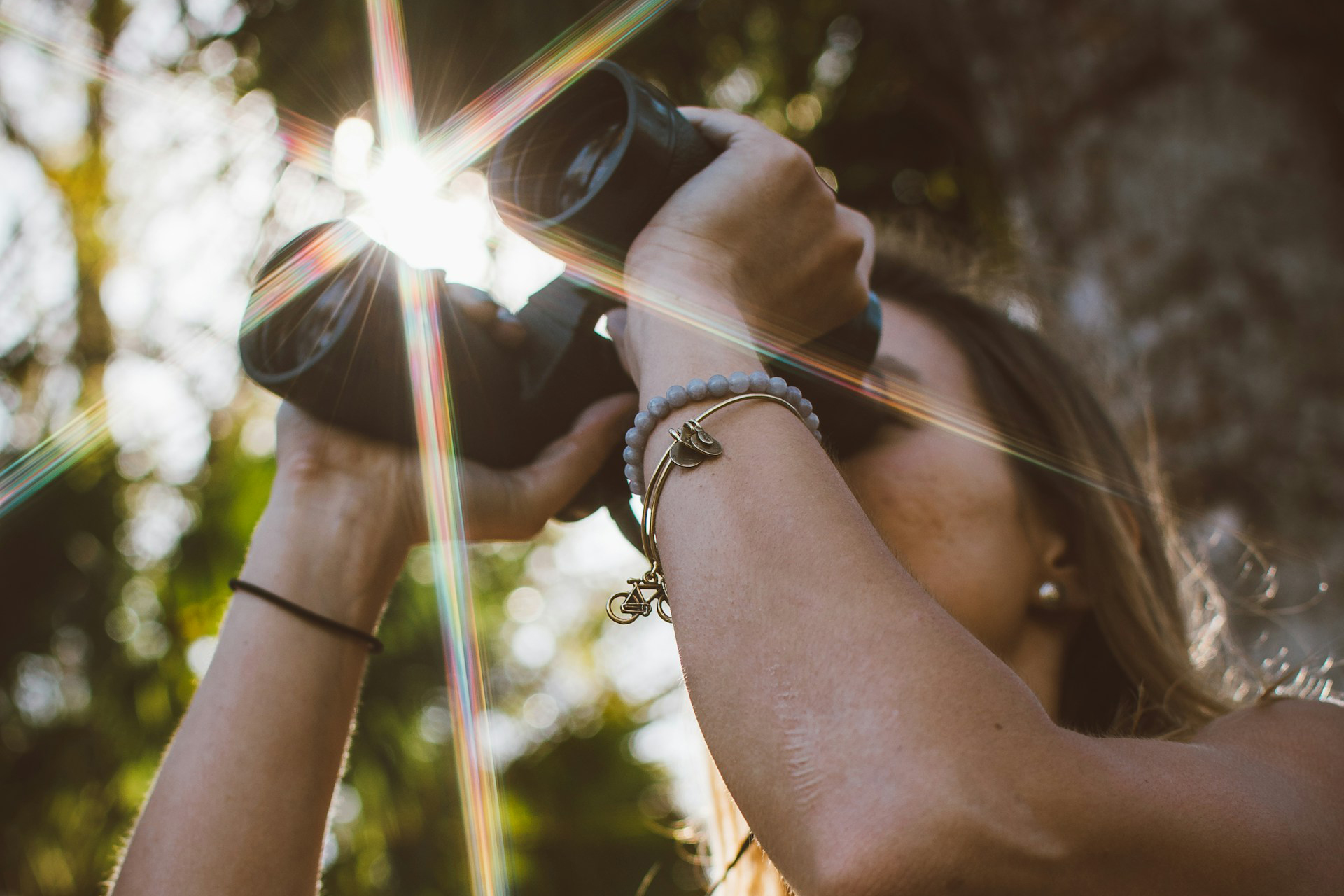 Young woman using binoculars in a natural setting