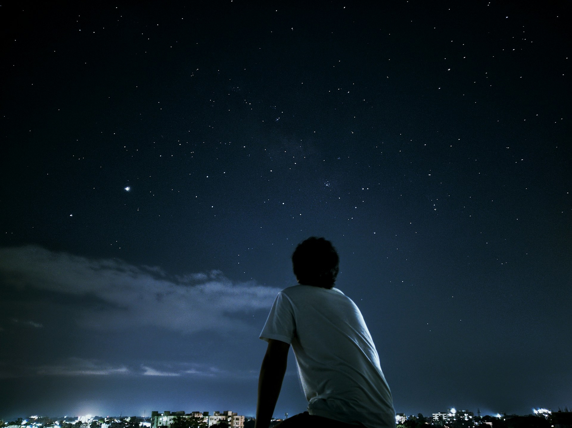 Man looking up at starry sky